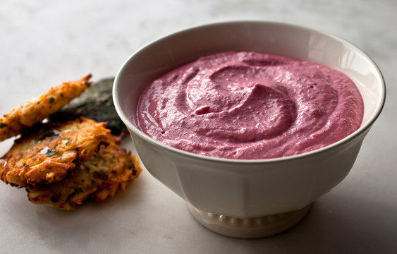 Close up of garlicky beet spread with yogurt in bowl