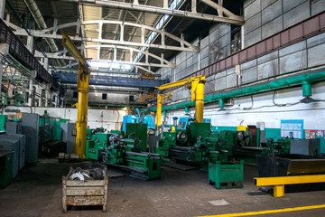 Machine shop of metallurgical works indoors room. Machining of metal by cutting on a turning and milling machine. Industrial machine old design. Lathe equipment.