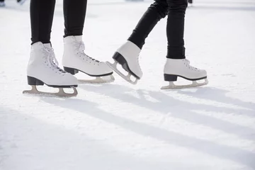 Fotobehang People ice skating on ice rink © Mariusz Blach