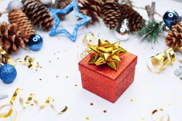 Christmas card: red gift box and Christmas tree branch on white background