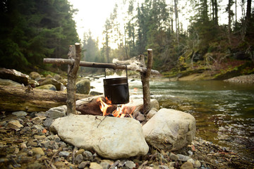 Cooking food in pot over campfire outdoor