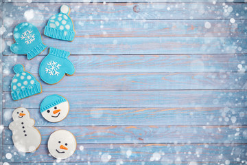 Christmas gingerbread cookies on blue wooden background with copy space for text. Holiday, celebration, festive and cooking concept. New Year and Christmas composition, postcard