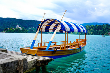 Naklejka na ściany i meble Gondolla with a striped roof on Lake Bled in Slovenia.