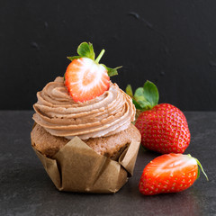 Homemade chocolate cake with cream and strawberry.