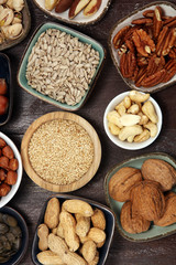 nuts composition on rustic table with walnut and peanut.