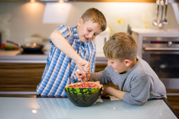 Happy little children, boy brothers with watermelon un house