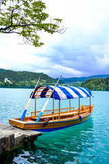 Fototapeta na wymiar Gondolla with a striped roof on Lake Bled in Slovenia.