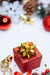 Christmas card: red gift box and Christmas tree branch on white background