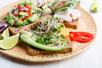 Selection of avocado toasts on grain bread. Healthy plant-based food