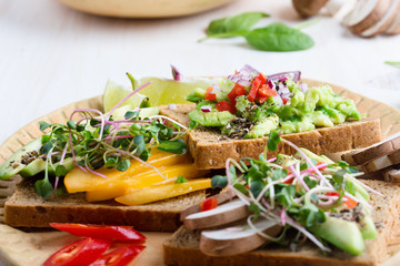 Selection of avocado toasts on grain bread. Healthy plant-based food