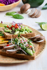 Selection of avocado toasts on grain bread. Healthy plant-based food