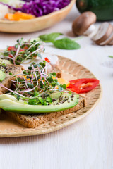 Selection of avocado toasts on grain bread. Healthy plant-based food