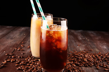 Ice coffee on a rustic table with cream being poured into it showing the texture and refreshing look of the drink