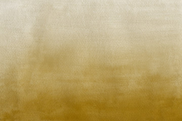 Gold watercolor texture with abstract washes and brush strokes on the white paper background.