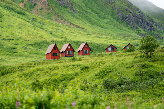 Abandoned red cabins sit in the green lush mountains of Alaska’s Hatcher Pass near Independence Mine.