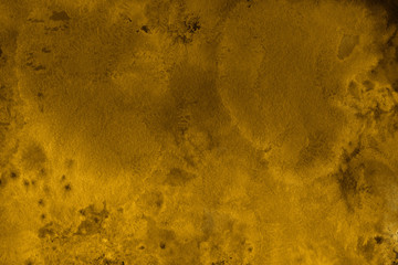 Gold watercolor texture with abstract washes and brush strokes on the white paper background.