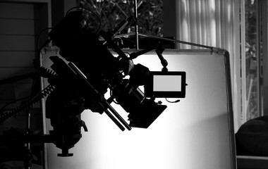 Silhouette images of video camera in tv commercial studio production which operating or shooting by...