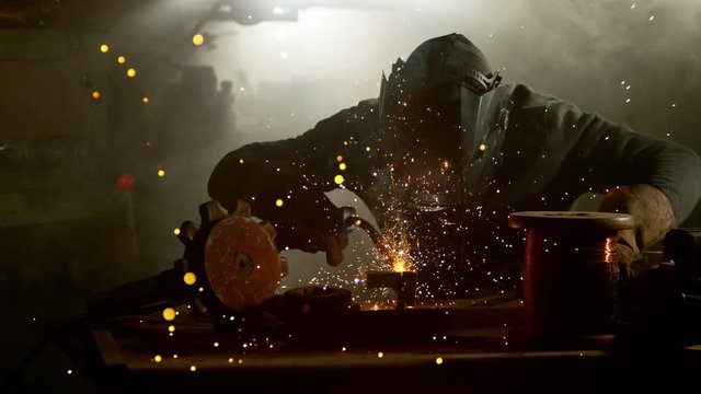 Super slow motion of working welder in workshop, filmed on high speed cinema camera