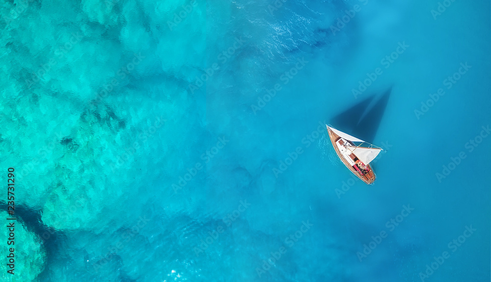 Wall mural yacht on the water surface from top view. turquoise water background from top view. summer seascape 