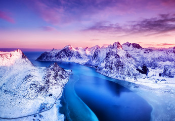 Aerial view at the Lofoten islands, Norway. Mountains and sea during sunset. Natural landscape from air at the drone. Norway at the winter time