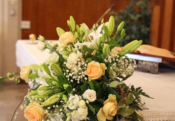 white and pink flowers decorate the altar of a church