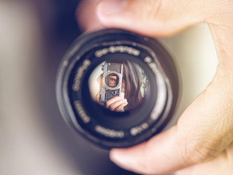 Reflection of woman in lens