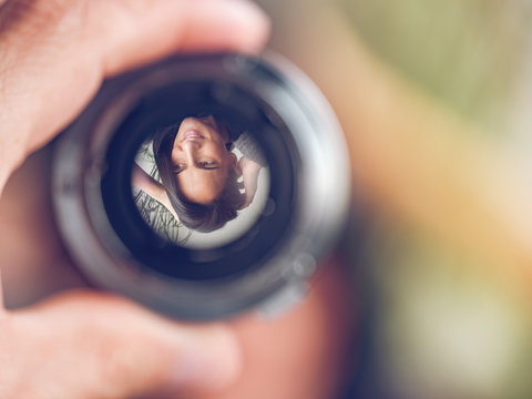Reflection of woman in lens