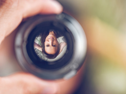 Reflection of woman in lens