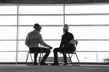 men engineers builders working at the table with a laptop, business negotiations at the...
