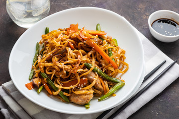 Asian noodles with pork in teriyaki sauce, with green beans, carrots and shiitake mushrooms.
