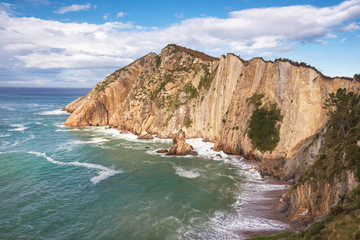 Fototapeta na wymiar Bay and cliffs in El silenio beach, Cudillero, Asturias, Spain.