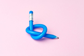 Flexible pencil on pink background. Bent pencils. Flexible business concept.