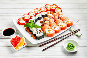 Closeup of traditional japanese sushi set with salmon and tuna fish isolated on white background. Sushi bar menu design with copyspace.