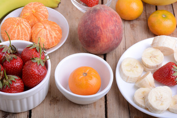 Close-up shot of variety of fruits on old wooden plate