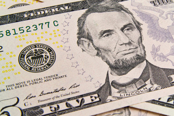 Front of the five dollar bill with a Portrait of President Abraham Lincoln close-up