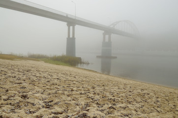 Fototapeta na wymiar Over the river there is a dense fog.