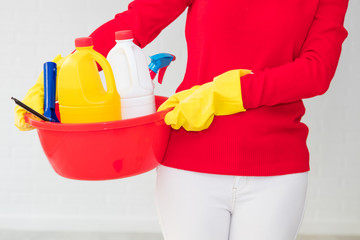 woman with utensils and cleaning products