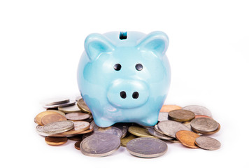 Piggy bank standing on coins. Blue piggy bank