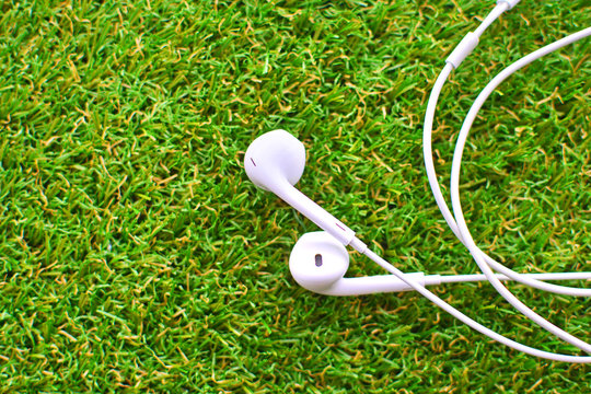 Headsets on a green artificial lawn. Sinthetic grass.