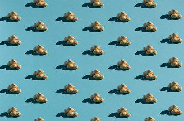 Peanut pattern with shadows on teal background. Flat lay. Minimalistic concept.