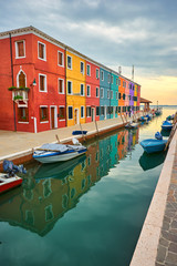 Fototapeta na wymiar Burano island canal, colorful houses and boats, Italy.