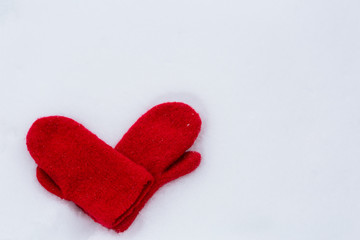 Heart shaped mittens on snow