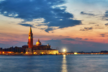 Fototapeta na wymiar Scenic view of St George Church and Island in the Giudecca Canal, as seen at night from St Mark's district in Venice