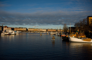 Fototapeta premium Commuting boats and Old steamboats at Skeppsholmen island in stockholm