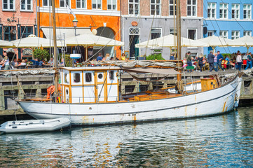Fototapeta na wymiar Old sailboat moored by Nyhavn