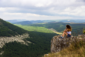 girl on the mountain looking into the distance