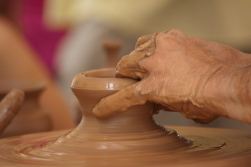 Potter hands working the mud