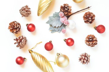 Obraz na płótnie Canvas Flat lay Christmas decoration. Gold baubles, red balls and pine cones. New Year ornament collection