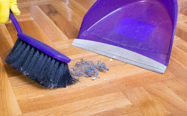 House keeper sweeping with dust pan