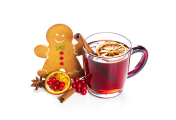 Hot red mulled wine with gingerbread cookie isolated on white background with christmas spices, orange slice, anise and cinnamon sticks